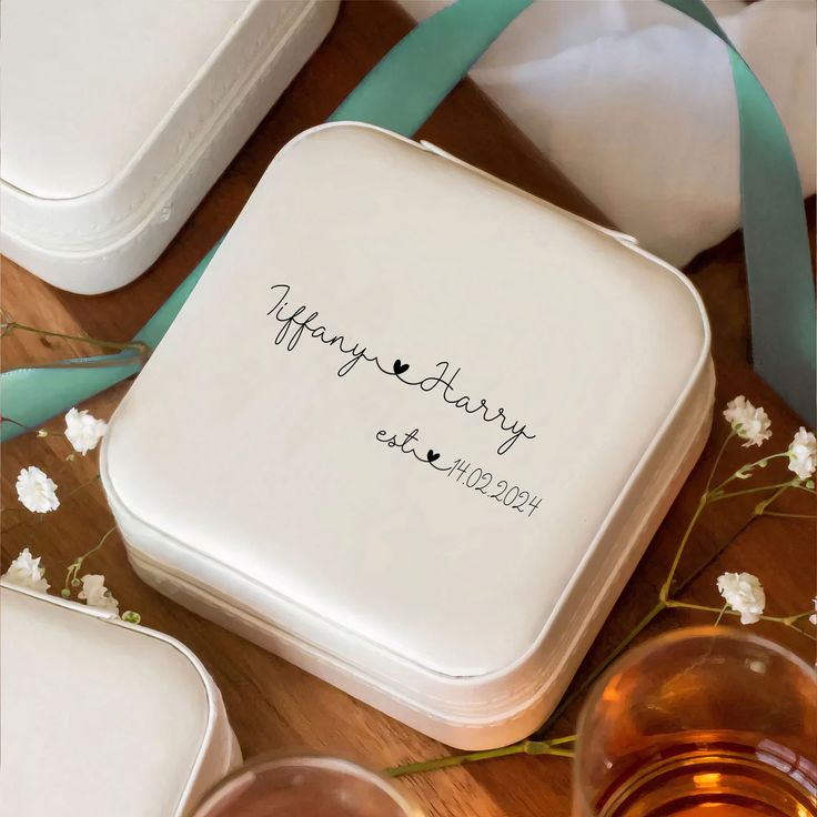 a white box with a happy birthday message on it next to some glasses and flowers