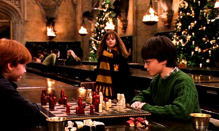 two young boys playing chess in a harry potter movie