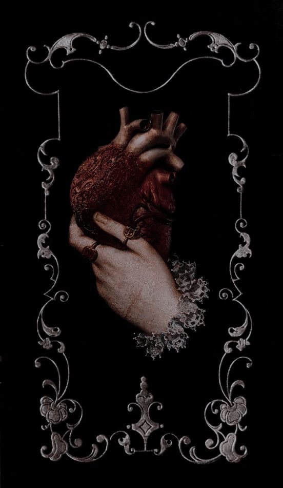 a woman's hand holding a heart in front of a black background