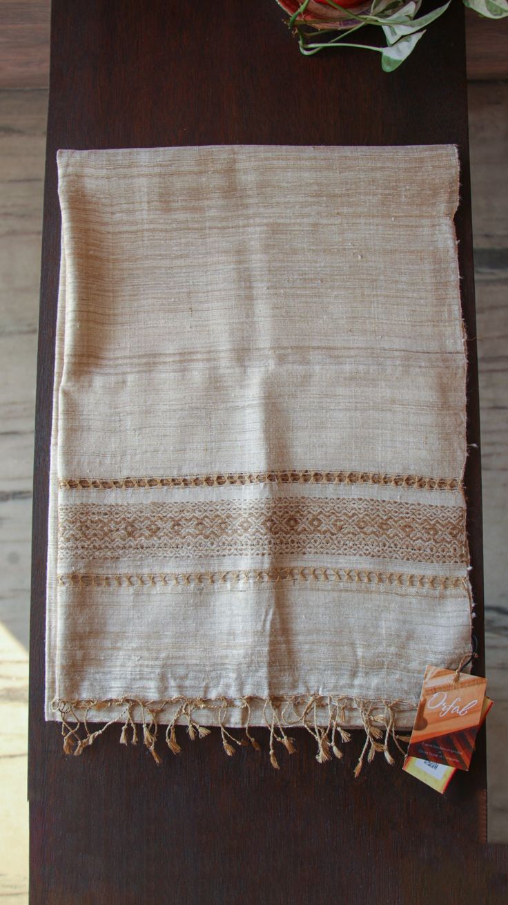 Wrap yourself in luxury with this elegant Muga Silk and Eri silk stole from Assam. Handwoven by skilled artisans using traditional techniques, this Stole is not only beautiful  but also eco-friendly.The Muga silk is wild silk,known for its extreme durability and has a natural  yellowish-golden tint with a shimmering, glossy texture.Eri silk is produced without killing the silk worm. The unique texture of the muga silk and Eri silk will keep you warm and cozy while adding a touch of elegance to a Elegant Shawl In Tussar Silk With Traditional Patterns, Elegant Tussar Silk Shawl With Traditional Patterns, Traditional Beige Silk Scarves, Elegant Raw Silk Pashmina Shawl With Traditional Patterns, Elegant Handloom Tussar Silk Pashmina Shawl, Traditional Beige Scarf For Wedding, Elegant Raw Silk Pashmina Shawl Handloom, Traditional Handmade Pashmina Shawl, Traditional Beige Silk Scarf