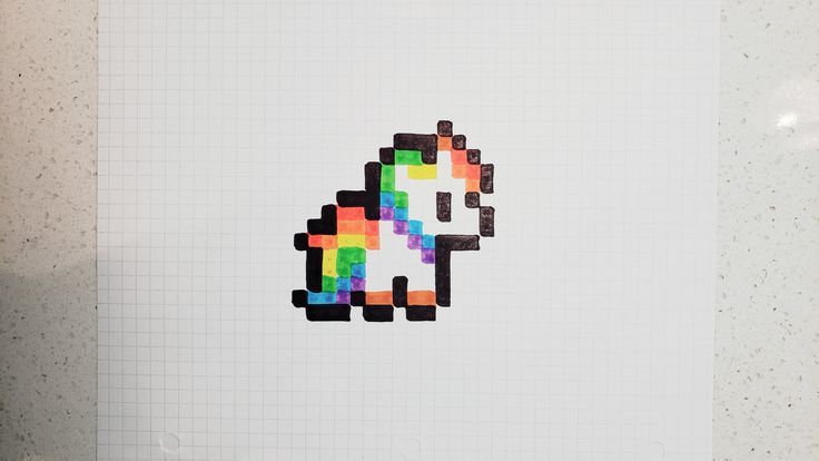 a piece of paper with an image of a unicorn made out of colored squares on it