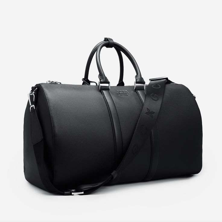 Explore elegance and utility in our Saffiano Leather Duffle Bag. Featuring intricate silver detailing and the GC logo, it makes a statement of sophistication. With two inside pockets and a removable shoulder strap, it's designed for versatility and functionality. Elevate your journey with this exquisite duffle bag. SIZE W 50 x H 29 x D 24 cm Luxury Duffel Bag, Black Leather Duffle Bag, High-end Epsom Leather Shoulder Bag For Everyday Luxury, Luxury Shoulder Bag With Silver-tone Hardware For Travel, Luxury Travel Shoulder Bag With Silver-tone Hardware, High-end Epsom Leather Bag For Everyday Luxury, Luxury Business Travel Bag With Adjustable Strap, Luxury Travel Bag With Adjustable Strap For Business, Luxury Saffiano Leather Shoulder Bag With Adjustable Strap