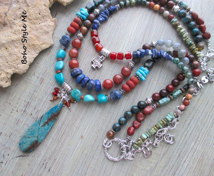 Colorado Springs, Boho Style Me Colorful Rustic Style Multi Strand Gemstone Necklace, BohoStyleMe, Artisan Beaded Turquoise Necklace In the style of the rustic Colorado mountains, this colorful, rustic, mixed gemstone necklace stands out as a striking multiple strand statement necklace. Starting with a beautiful chrysocolla beaded pendant is a trail of genuine turquoise, lapis lazuli, carnelian, labradorite, iolite, sodalite, and a large mix of jasper stones. Directly above the pendant is strand with a row of gorgeous lapis disc beads, labradorite, and mixed jasper stones. The top strand holds a pewter templars cross, surrounded my additional gemstones. Pewter is used throughout, as well as mixed silver metal - enjoy! Length - 30 inches (longest), 24 inches (shortest). Chrysocolla pendant Green Bohemian Beaded Necklaces With Stones, Bohemian Green Beaded Necklaces With Stones, Bohemian Beaded Turquoise Necklace For Meditation, Bohemian Beaded Necklaces With Round Stones, Bohemian Blue Beaded Necklaces With Stones, Multicolor Hand-strung Spiritual Turquoise Necklace, Blue Bohemian Beaded Necklaces With Stones, Handmade Multicolor Bohemian Turquoise Necklace, Spiritual Multicolor Hand-strung Turquoise Necklace