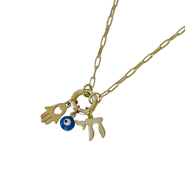 This meaningful necklace features three powerful symbols: the Jewish Chai for life, the Evil Eye for protection, and the Hamsa for blessings and strength. Wear it as a reminder of spiritual security and positive energy, keeping life’s blessings close to your heart. - Metal: Brass.- Plating: Long Lasting 14K Gold Plating. - Chain length: 16" and 2" adjustable. - Pendants Sizes: Aprox. 19 mm long x 10 mm wide (Hamsa), 12 mm x 10 mm (Chai) and 6 mm wide (Evil Eye). - Closure: Lobster Clasp. - Chain 14k Gold Spiritual Pendant Charm Necklace, Gold Plated Amulet Necklace For Blessing, Handmade Brass Spiritual Charm Necklace, 14k Gold-filled Spiritual Charm Necklace With Adjustable Chain, Spiritual Evil Eye Metal Necklace, Meaningful Necklace, Gold Necklace, Gold Plate, Plating