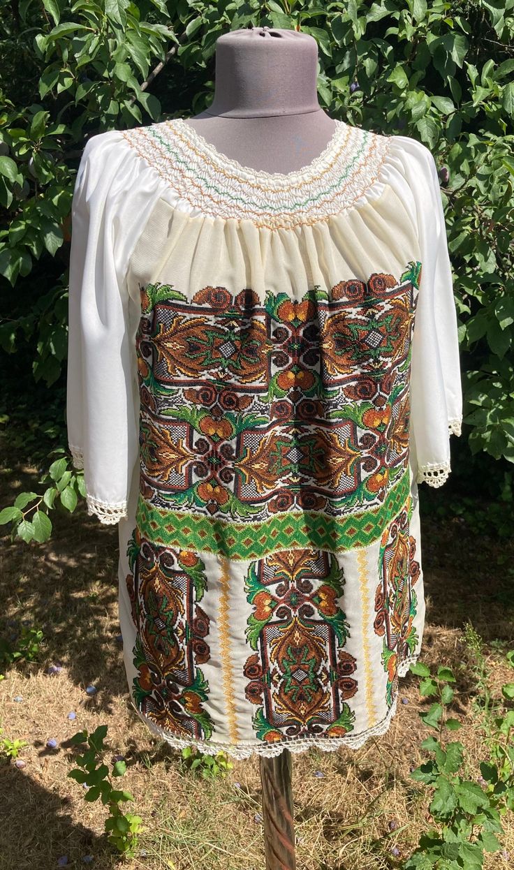 "Vintage  folk cross stiched  handembroidered blouse . Peasant blouse, embroidered blouse, embroidered peasant blouse, floral blouse, ethnic embroidered blouse Beautiful wide shape boho, hippie, folk blouse with floral embroidered pattern.  Handmade blouse Bust : 42\",   110 cm Lenght 27\"  70 cm Hand wash only. If you are buying several pieces I can combine postage at the time of mailing. If you have any question please don't hesitate to contact me,  My etsy shop: https://www.etsy.com/shop/TreasuryCoffer" Folk Style Peasant Tunic Top With Floral Embroidery, Folk Style Peasant Top With Floral Embroidery, Traditional Peasant Top With Floral Embroidery For Fall, Bohemian Embroidered Peasant Top For Spring, Bohemian Embroidered Peasant Top For Fall, Traditional Fall Peasant Top With Floral Embroidery, Spring Bohemian Embroidered Peasant Top, Spring Bohemian Blouse With Embroidered Hem, Bohemian Fall Blouse With Embroidered Hem