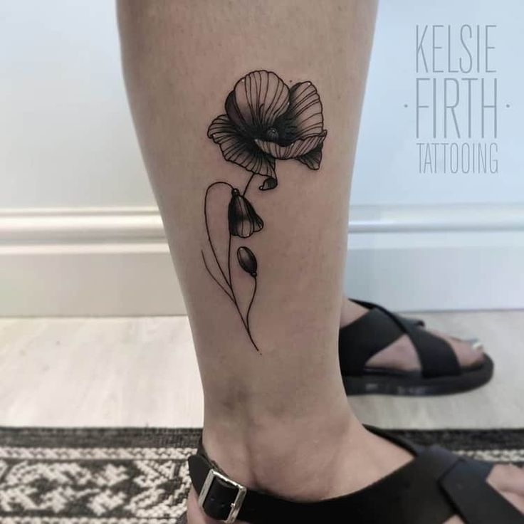 a woman's foot with a flower tattoo on the lower part of her leg