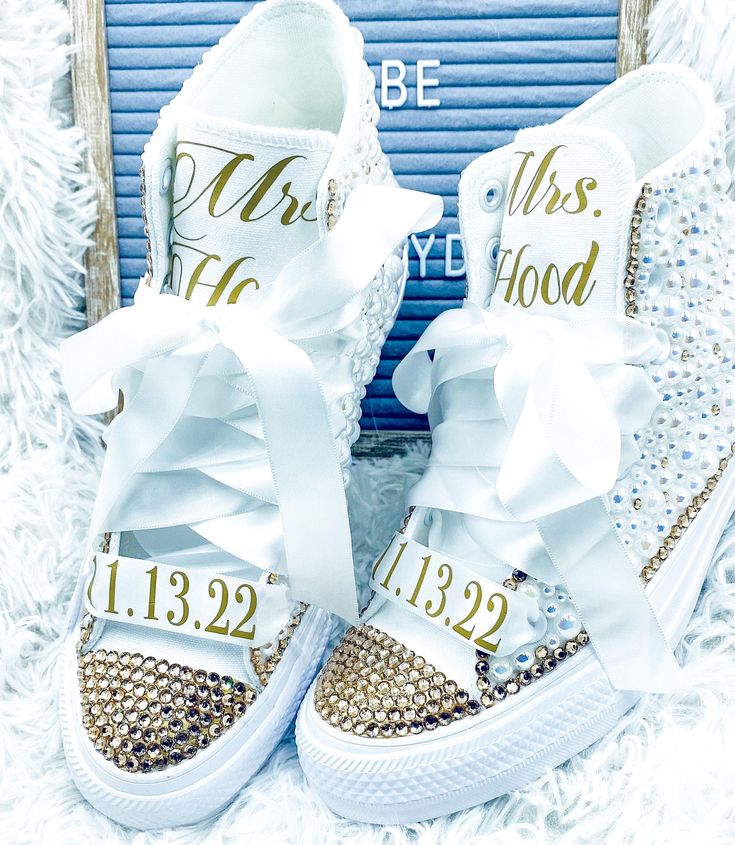 PERSONALIZED HIGHTOP Encrusted with Crystals and high quality pearls. Youth and women’s Available - Handmade. 💖💖💖💖💖💖💖💖💖💖💖💖💖💖💖💖 CURRENT PROCESSING TIME IS 2-3 WEEKS 💖💖💖💖💖💖💖💖💖💖💖💖💖💖💖💖 These iconic sneakers gets a stylish new boost on the feminine yet edgy style. The sneakers come with silver rhinestones, pearls, and white satin laces. Design: All shoes are handmade to order and embellished with a variety of high-quality crystals and resin pearls. Great for reunions, Bridal Sneakers Brides, Wedding Sneakers For Bride, Bridal Shop Ideas, Laces Design, Bedazzled Shoes Diy, Bride Sneakers, Bling Wedding Shoes, Iconic Sneakers, Converse Wedding Shoes