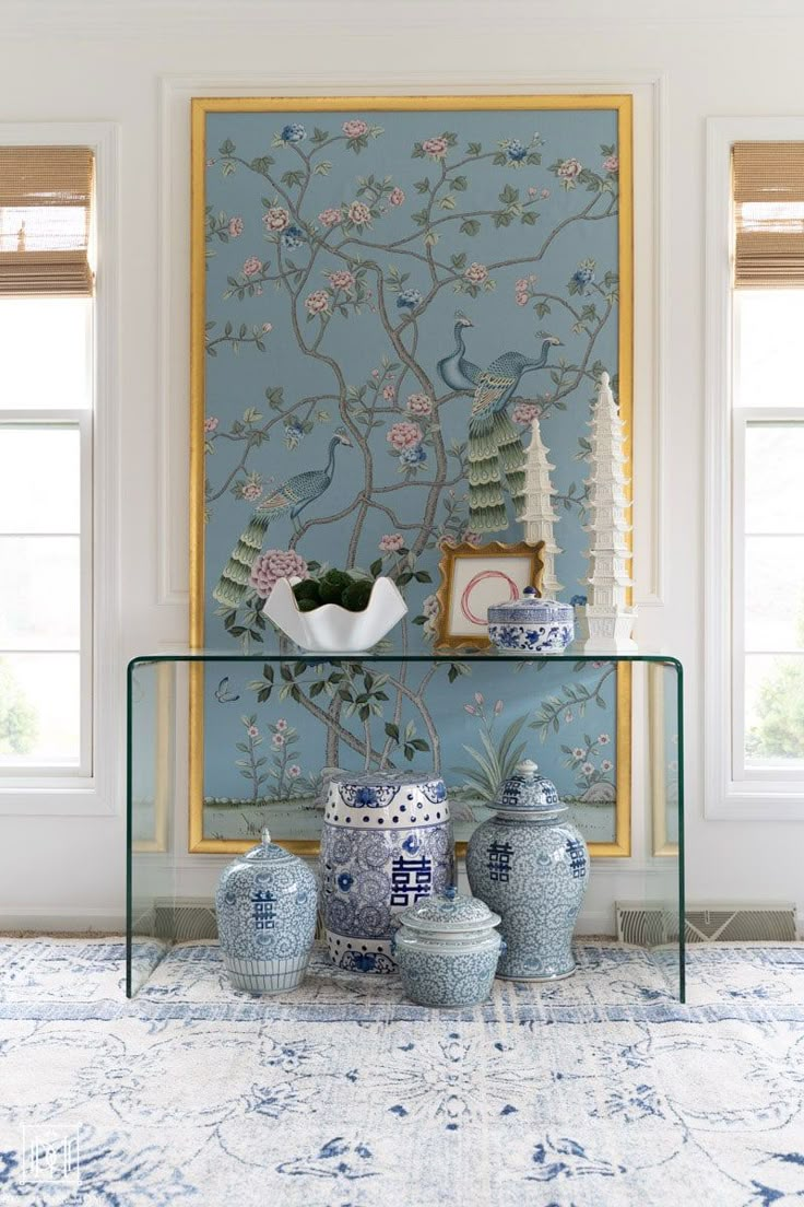 a blue and white room with vases on the table