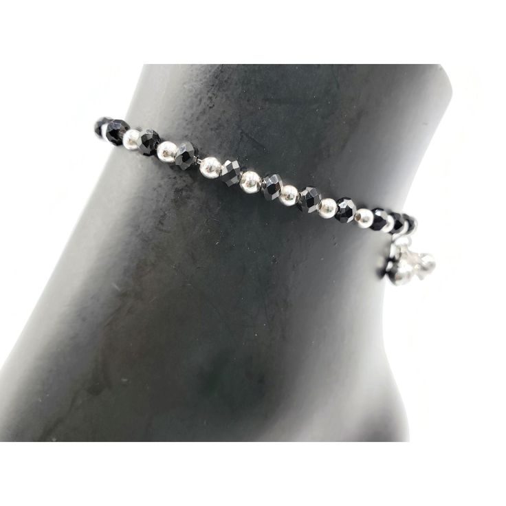 "Description 925 Sterling Silver Stretchable Black Bead Anklet (92.5% Silver purity) available in four lengths from from 4.5 inch (0-12 month) ,5.5 inch (1-3 Years) 6.5 inch (4-9 Years) & 7.5 inch (10-12 Years)and suitable for daily use. Makes low bell / charms sound \"chann-chann-chann\", weaved with NYLON Flexible elastic WIRES and stretchable . SOLD IN PAIRS. Dimensions Anklet Weight: ~8.0-12.0 grams / pair. 1 Pair 4.5-inch + 0.5 inch (nylon stretchable Extension) Anklet: ~8.0-9.0 grams ( Adjustable Silver Beads Anklet For Party, Black Bracelets With Tiny Beads For Party, Black Anklets With Round Beads For Gift, Adjustable Black Anklet With Tiny Beads, Elegant Black Beaded Anklets, Elegant Adjustable Anklets With Silver Beads, Handmade Adjustable Black Anklet, Black Beaded Bracelets With Silver Beads For Party, Bead Anklet