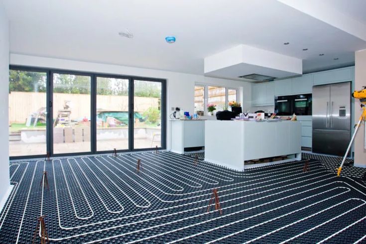 a large kitchen with an open floor that has been installed and is being worked on