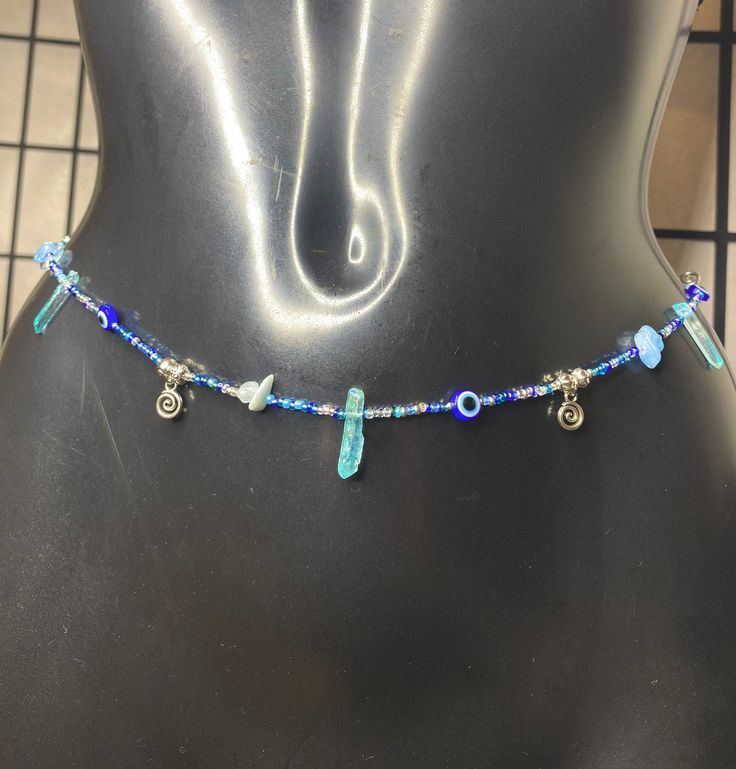 Boho Hippie Blue Evil Eye Beads with Natural Aquamarine Gemstones & Blue Quartz Pillar Rock Crystals Stones Waist Beads Waist Chain Belly Chain  Silver Pendants & Detailing  Body Jewellery  Silver screw clasp Made to fit Waist line / Upper hip line / hip line  Check out more of my waist Beads collection 🤍 https://etsy.me/3JbHvCJ Beaded Dangle Crystal Necklaces For Festivals, Blue Beaded Necklaces With Stones For Jewelry Making, Blue Gemstone Beads Jewelry For Beach, Blue Beaded Chain Bracelets For Party, Blue Bohemian Crystal Necklaces For Party, Blue Bohemian Crystal Necklace For Party, Bohemian Blue Crystal Party Necklace, Blue Gemstone Beads Festival Bracelet, Blue Czech Glass Beads For Beach