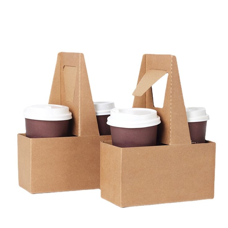 two brown boxes with coffee cups in them