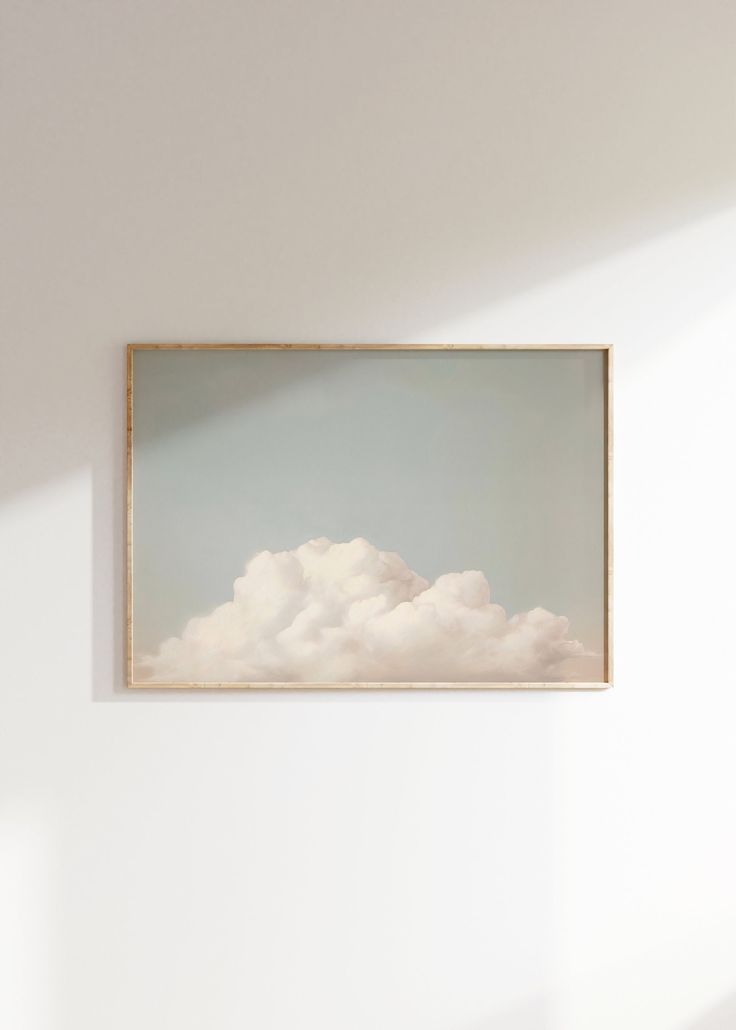 a painting hanging on the wall above a bed in a room with white walls and flooring