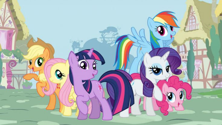 many different colored ponies are standing together