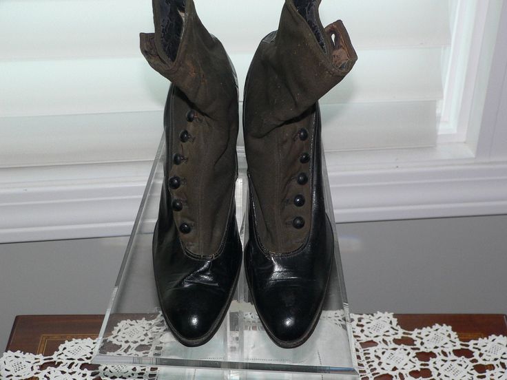 These women's boots are from the late 1890 to early 1900's. They are black leather and blackish brown heavy cotton, canvas, or wool. They have the side black buttons for closure. Makers label inside E. P, REED & Co Rochester NY on the inside of the cotton lining along with style numbers and also on the sole, Inside is lined in a cream linen or cotton. The inside bottoms are stuffed. Wood staked heels had 3 tiny metal nail. On inside of each heel is a sticker 6915 which does not match the ins Leather Cap Toe Boots With Buttons, Victorian Boots For Formal Fall Occasions, Winter Leather Boots With Buttons, Victorian Boots With Leather Sole For Fall, Vintage Leather Boots With Buttons, Victorian Black Boots With Round Toe, Black Victorian Boots With Round Toe, Victorian Black Boots For Formal Occasions, Black Victorian Boots For Formal Occasions