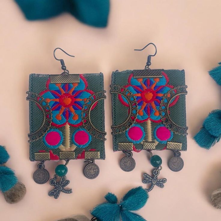 the earrings are decorated with beads and tassels