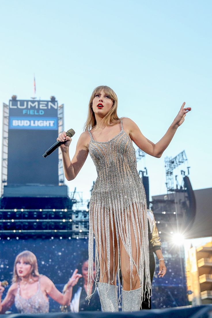 taylor swift performs on stage at the concert