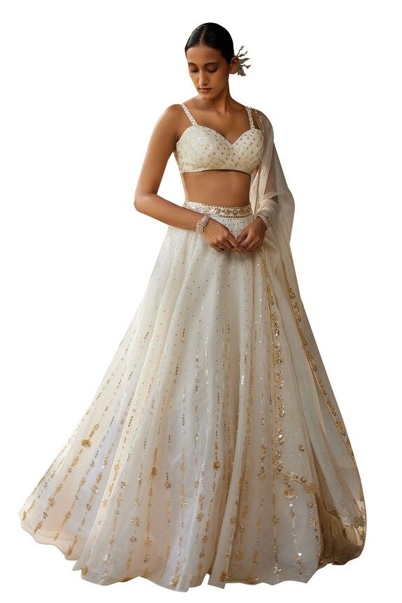 Ivory skirt with aari, sequin, thread embroidery in floral pattern. Paired with sleeveless embroidered padded blouse and dupatta. - Aza Fashions Embellished Embroidered Fabric For Wedding, Festive White Dress With Gold Embroidery, Elegant Organza Lehenga With Gold Embroidery, Embellished Off White Dress For Reception, Embellished Off-white Dress For Reception, Fitted Bollywood Style Embroidered Off White Fabric, Fitted Bollywood Style Off White Embroidered Fabric, Fitted Off White Bollywood Embroidered Fabric, Bollywood Style Fitted Off White Embroidered Fabric