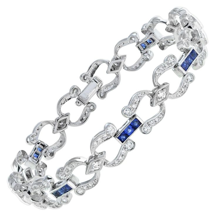 Handcrafted out of stunning French-cut blue sapphires and diamonds, this bracelet is perfect for evening or day wear. Each individual section features round diamonds and is separated from its neighbor with a sapphire line. This wonderful piece is a must-have for any Art Deco fanatic! Bracelet Information Metal: 18K White Gold Width: 9 mm. Length: 179 mm. Weight: 20.40 g. (approx. in total) Clasp: Push Clasp Gemstones I Type: Sapphire Shape: Square French Cut Size: 2.5 mm. Number: 24 Weight: 3.12 Carat (approx. in total) Gemstones II Type: Diamond Shape: Round Average Color: G Average Clarity: VS Size: 1.1 – 2 mm. Number: 136 Weight: 1.87 Carat (approx. in total) This bracelet will be made to your order in 1-2 weeks, contact us to find out more. An attractive bracelet box is included.  We d Square French, Sapphire And Diamond Earrings, Bracelet Box, White Gold Sapphire, French Cut, Gold Art Deco, Art Deco Diamond, Sapphire Diamond, Art Deco Style