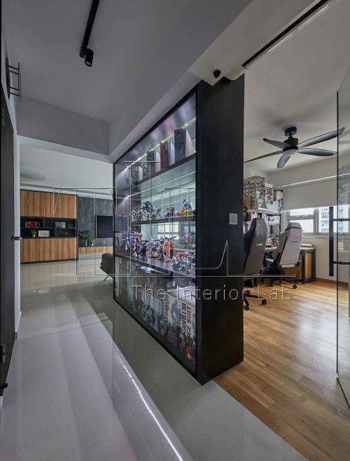 an office with glass walls and wooden flooring is seen in this image from the hallway