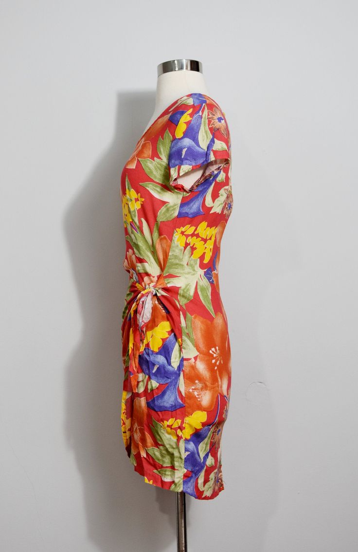 "If you love rayon and you love a sarong dress, this is the dress for you! The colorway makes me think of a summer evening, with its warmer palette. The rayon is soft and has a great drape, as usual. Lovely! 100% Rayon Marked size 3 No visible flaws! Bust 34\" Waist 28\" Hips 36\" Length 32\" ------------------------------------------------------------------------------------------------------- SEE MY SHOP at www.etsy.com/shop/MagicSummerVintage -------------------------------------------------- Summer Draped Wrap Dress, Fitted Draped Dress For Vacation, Fitted Draped Wrap Dress For Summer, Silk Wrap Dress For Summer, Silk Ruched Beach Dress, Silk Ruched Dress For The Beach, Spring Rayon Draped Dress, Orange Draped Summer Dress, Spring Draped Rayon Dress