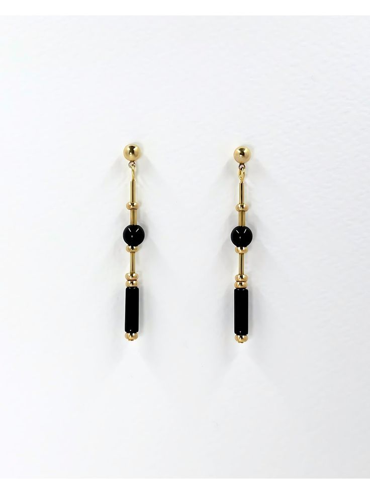 These long, dangle earrings feature polished onyx stone.  The geometric cut of the stone and brass elements creates a modern and minimalistic design while the variation in shapes adds detail and interest. The deep black of the onyx stone and the warm, metallic tone of the brass highlights the materials and creates contrast.  The earrings are finished with brass ball stud with stainless steel earring post.  Onyx is a semi precious gemstone known for its striking black color and smooth, glossy app Minimalist Black Drop Earrings, Minimalist Black Linear Drop Earrings, Minimalist Black Long Drop Earrings, Modern Black Long Drop Jewelry, Minimalist Black Linear Earrings For Gifts, Minimalist Black Linear Earrings As Gift, Modern Onyx Drop Earrings, Set Theory, 1920s Jewelry