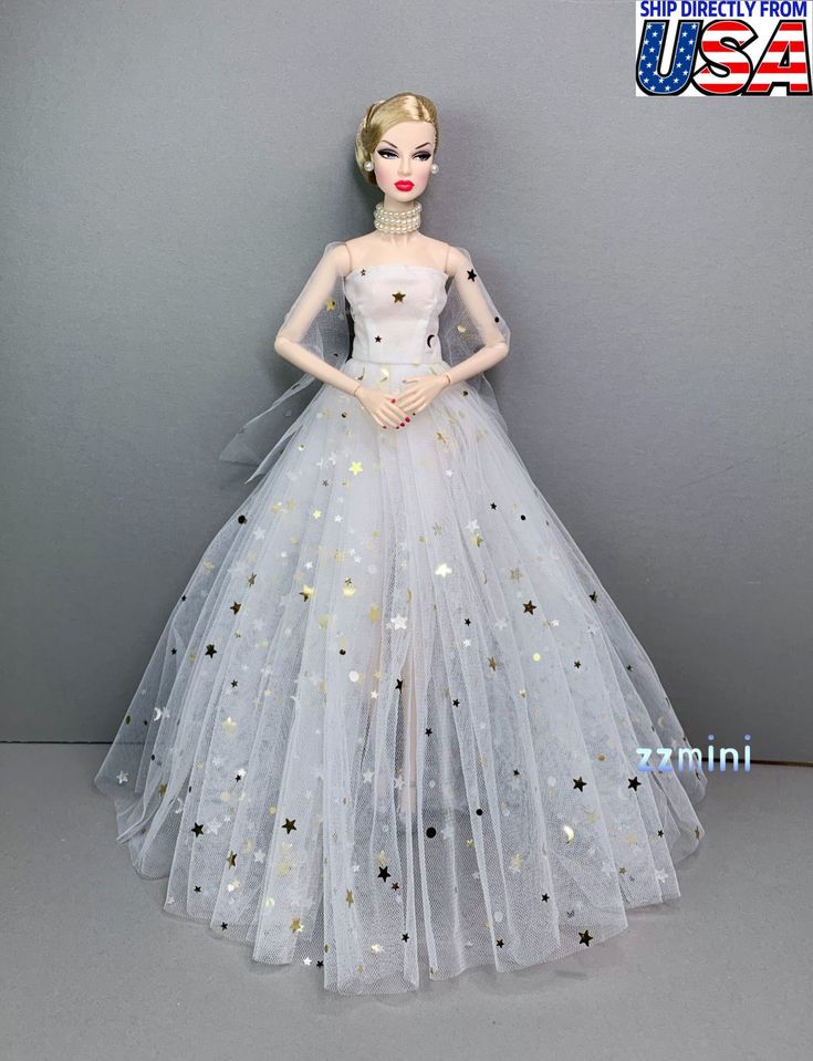 a barbie doll wearing a white dress with stars on it