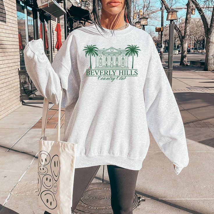 Be the envy of the Hills with our Beverly Hills Crewneck Sweatshirt. Stay cozy and stylish while showcasing your love for the famous city. A must-have for any trendsetter. Only a limited number available, so grab yours now! The Hills, Stay Cozy, Ash Grey, Beverly Hills, Trend Setter, Crewneck Sweatshirt, Must Haves, Ash, Crew Neck Sweatshirt