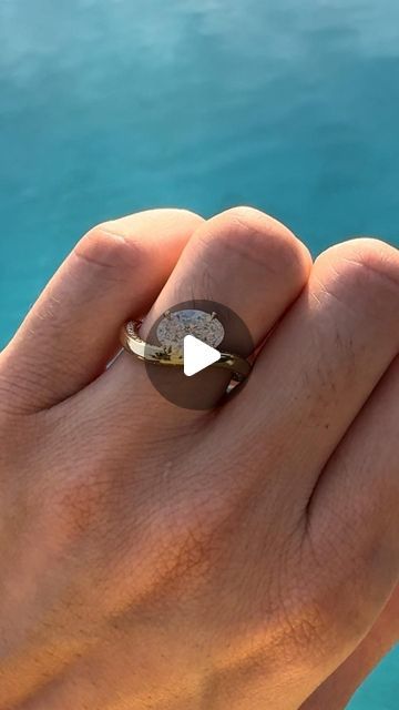 a person's hand with a ring on it