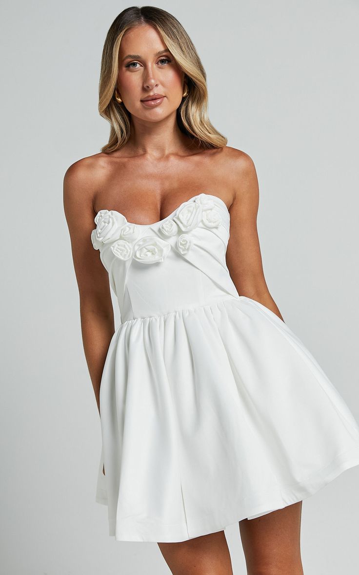 Angeletta Mini Dress - Sweetheart Rosette Detail Fit & Flare in White | Showpo Summer Bridal Shower Dress With Sweetheart Neckline, Spring Mini Dress For Bridal Shower, White Feminine Corset Dress With Ruched Bodice, Flirty Mini Wedding Dress, Flirty White Corset Dress With Boned Bodice, Flirty Mini Dress For Wedding, Feminine Mini Dress With Heart-shaped Neckline For Party, White Mini Dress With Sweetheart Neckline And Ruffles, White Mini Dress With Ruffles And Sweetheart Neckline