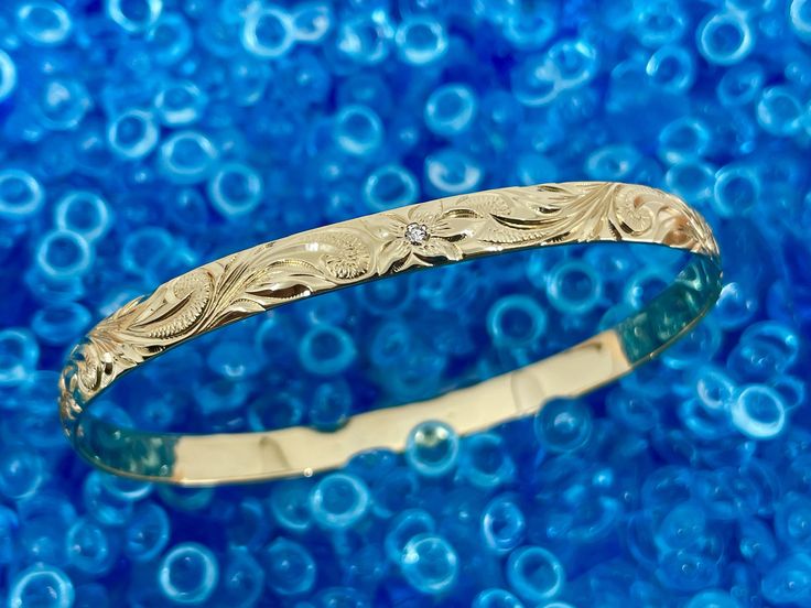 We have been getting a lot of requests for engraved Hawaiian Heirloom Bangles in solid 14K Gold. So many people want to give a gift of Gold that will be a legacy and something they can pass down for many generations. The Hawaiian Heirloom Scroll Bracelet has been around since the 1800's and you see many locals wearing them today. With Gold prices rising we managed to secure a great price on this 6mm width (approx. 14/ inch wide) which is on trend and the most requested width. As a bonus you get Traditional Engraved Gold Bracelet, Artisan Gold Bracelet With Engraved Details, Artisan Gold Engraved Bracelets, Artisan Gold Bracelet Engraved, Artisan Engraved Gold Bracelets, Artisan Gold Bracelets Engraved, Traditional Engraved Gold Bracelet Gift, Hawaiian Quilts, Beautiful Fish