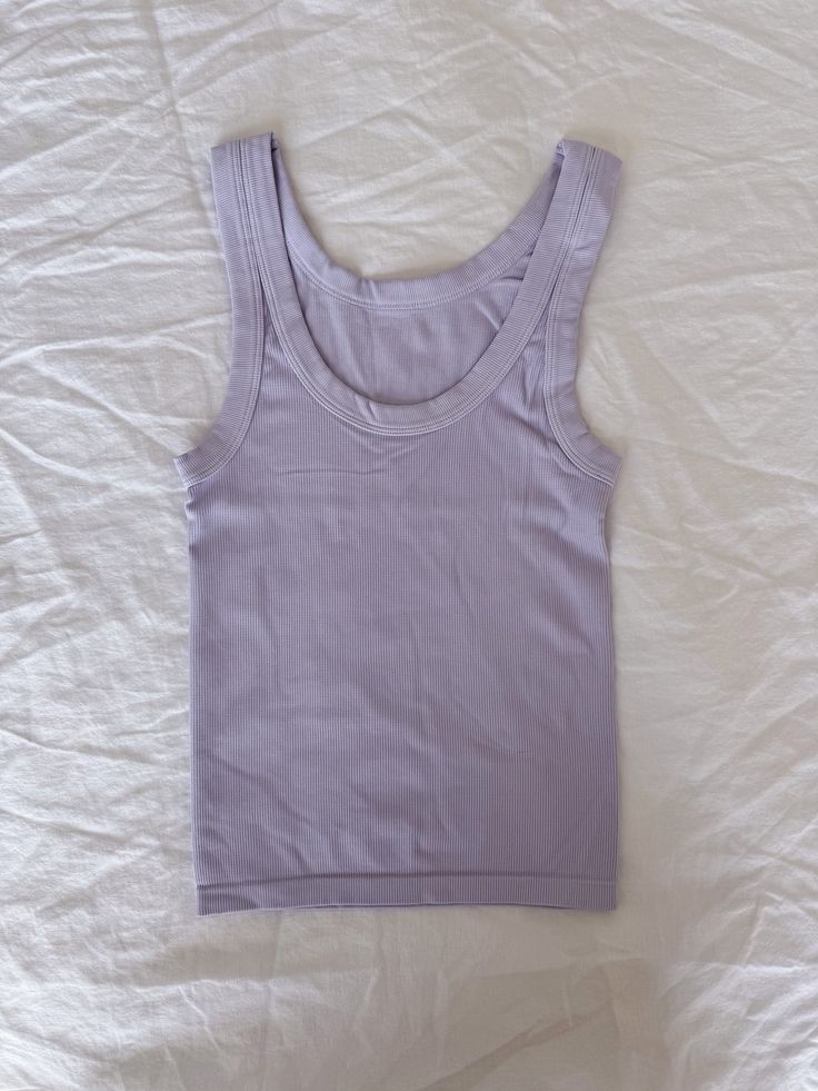 These cute tanks are one size fits most! Trendy Solid Color Tank Top For Loungewear, Casual Purple Cotton Tank Top, Purple Cotton Tank Top For Spring, Spring Purple Cotton Tank Top, Solid Color Tank Top For Loungewear, Trendy Purple Sleeveless Top, Lavender Sleeveless Tank Top For Spring, Spring Lavender Sleeveless Tank Top, Purple Tank Top For Summer Loungewear