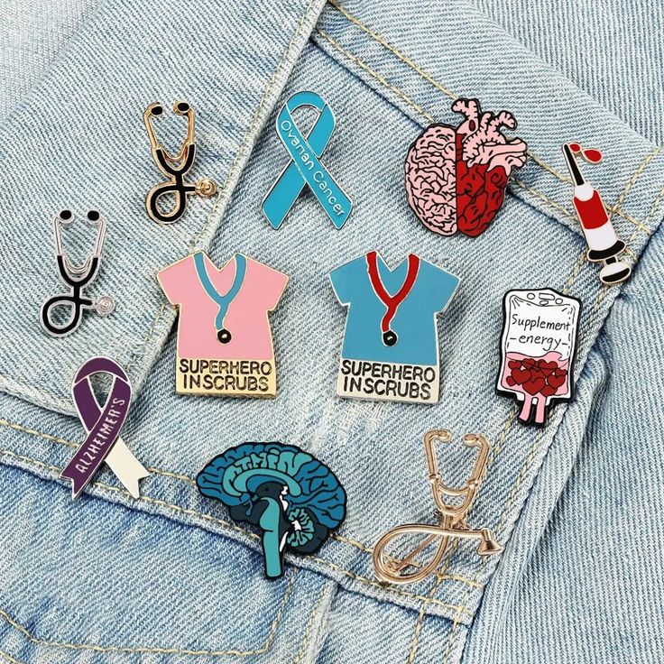 various pins and badges in the pocket of someone's jean jacket, including an open heart