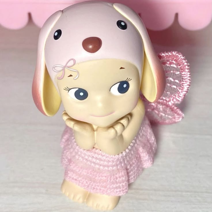 a small toy dog wearing a pink dress