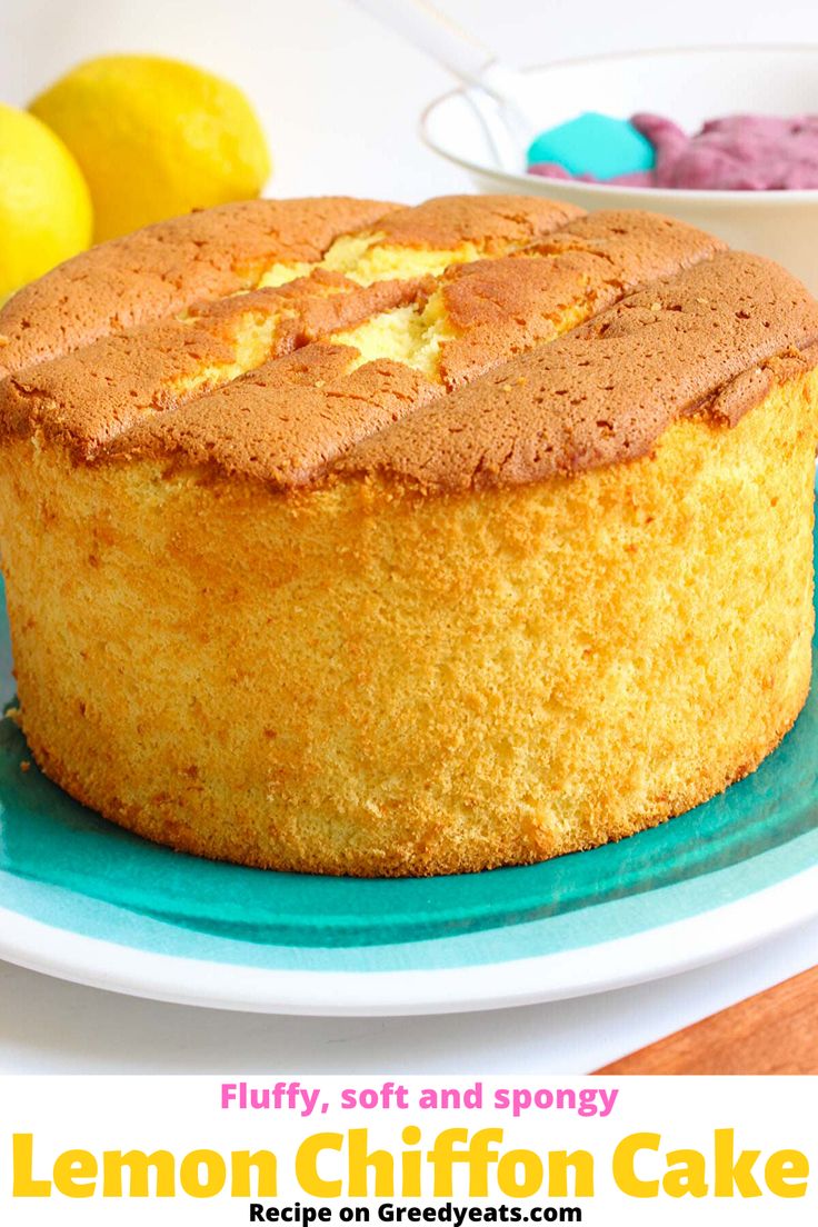 a cake on a plate with lemons in the background