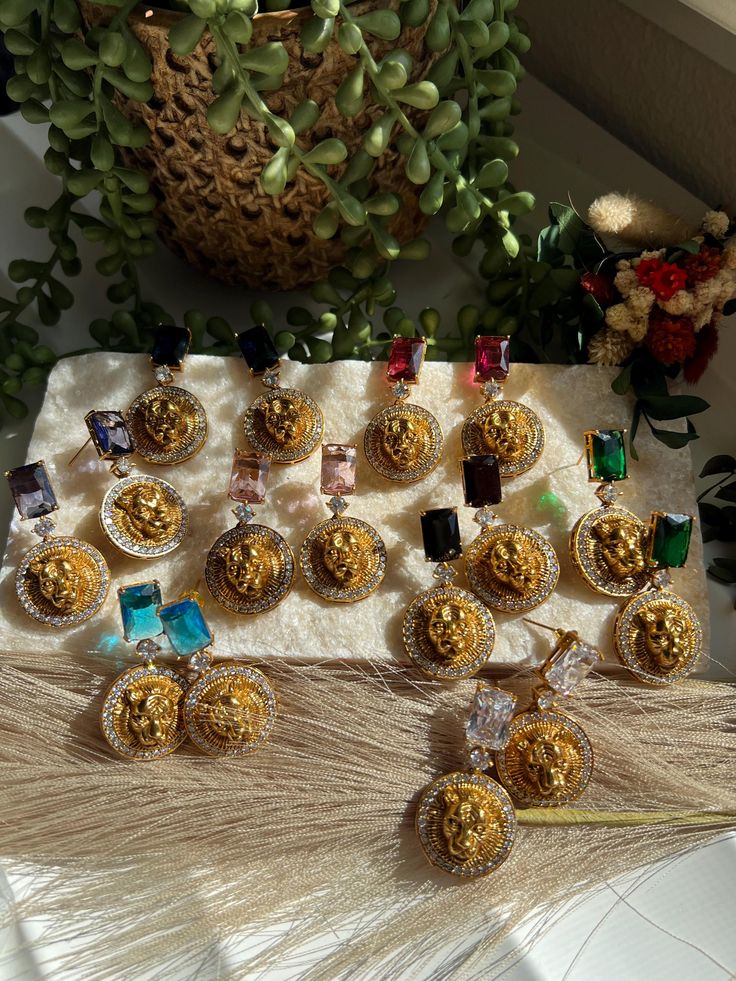 a table topped with lots of desserts next to a potted plant