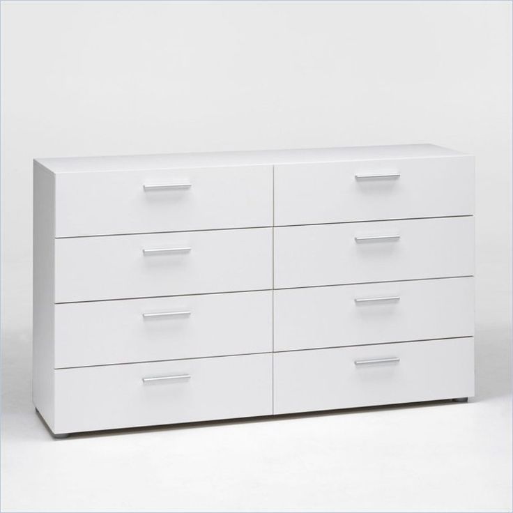 a white dresser sitting on top of a white floor