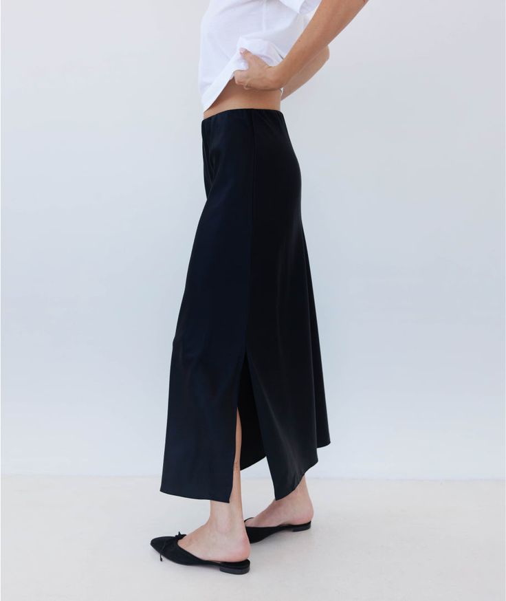 We continue to perfect our slip skirt. Once you slip on this insanely luxe silky charmeuse skirt, you'll realize that it's the sexiest companion you've ever seen to every tank top, knit top, sweater, blouse and button down you own (truly–this pairs with everything, it's like magic). It works with heels, sandals, loafers and even sneakers. It's possible that you may go through a phase where you wear nothing else. HERE FOR IT. Spring Satin Skirt For Night Out, Chic Silk Skirt For Fall, Spring Date Night Satin Skirt, Silk Asymmetrical Skirt For Night Out, Summer Satin Skirt For Date Night, Summer Date Night Satin Skirt, Sleek Long Maxi Skirt For Spring, Chic Bias Cut Maxi Skirt, Casual Satin Lined Skirt