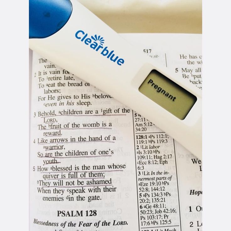 a digital thermometer sitting on top of an open bible