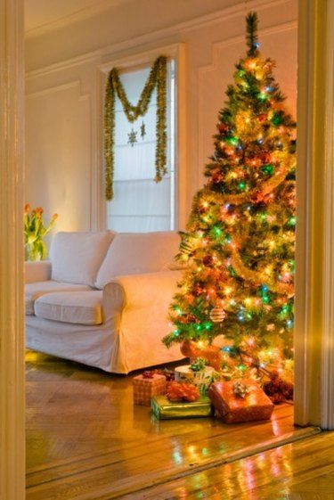 a decorated christmas tree in the corner of a living room