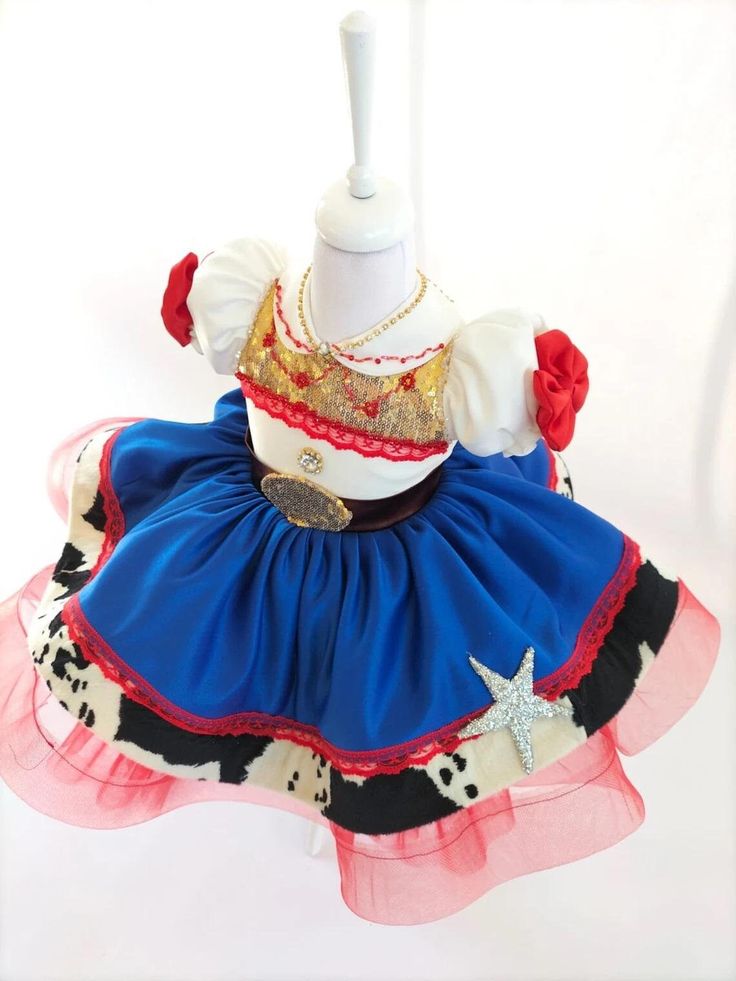 a dress made to look like a cowgirl with red, white and blue ruffles