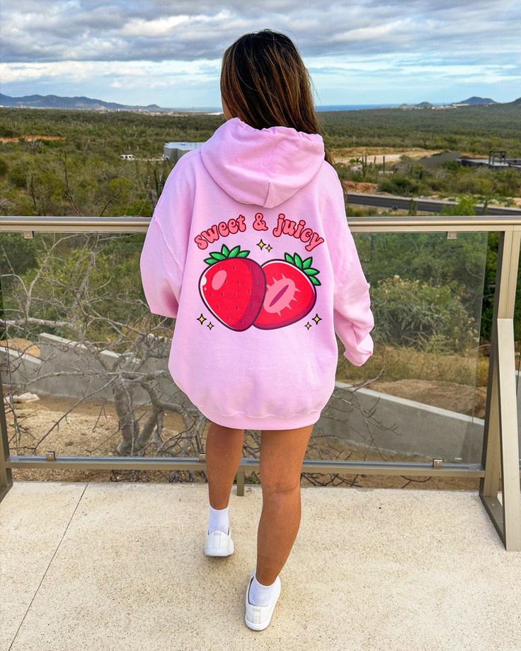 PLEASE NOTE: This is an adult UNISEX hoodie. If you want an oversized look then consider ordering up a size. This kawaii strawberry hoodie will look very cute on you! There are no side seams. A kangaroo pocket hangs in front. The hood's drawstring is the same color as the base sweater. .: 50% cotton, 50% polyester .: Medium-heavy fabric (8.0 oz/yd² (271 g/m .: Classic fit .: Tear-away label .: Runs true to size Pink Harajuku Hoodie With Drawstring, Kawaii Hoodie Sweatshirt With Drawstring, Pink Kawaii Hoodie With Drawstring Hood, Pink Kawaii Hoodie Sweatshirt, Pink Kawaii Sweatshirt With Drawstring Hood, Y2k Pink Hoodie With Letter Print, Cute Pink Hoodie For Streetwear, Pink Kawaii Hoodie With Letter Print, Kawaii Pink Crew Neck Hoodie