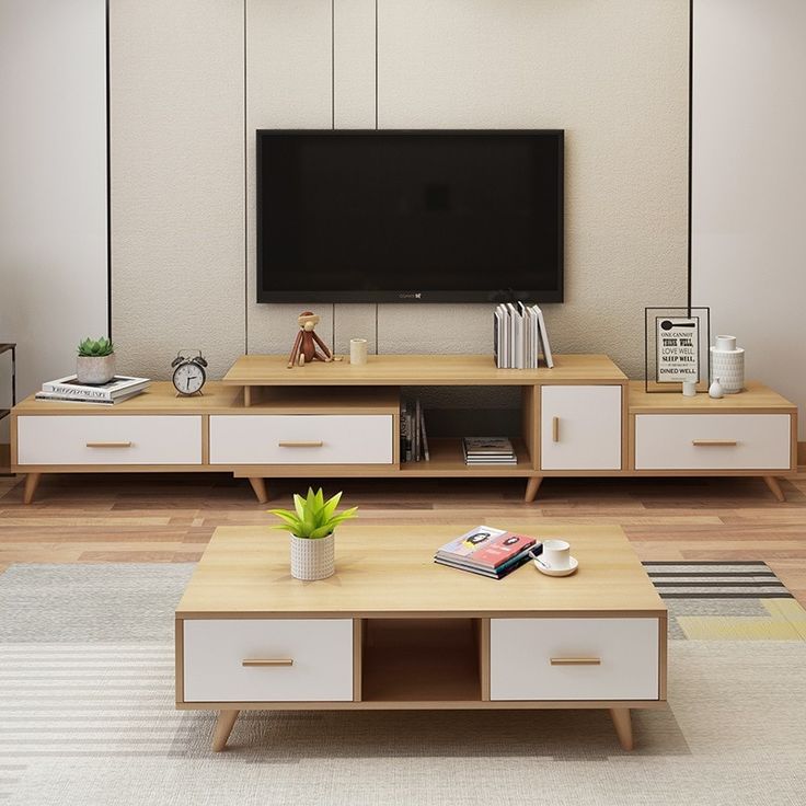 a living room scene with focus on the coffee table and television set in the background