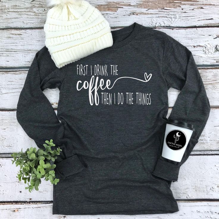 Custom made to order FIRST I DRINK THE COFFEE THEN I DO THE THINGS funny coffee drinkers t-shirt.  Great with jeans, leggings or pj pants! Photo shows Matte White Design on a Dark Heather Grey Long Sleeve Tee.  Choose from short sleeve or long sleeve tees.  (Not all colors may be available in long sleeve.  Please see color chart for long sleeve colors.)   These soft and comfy boyfriend style shirts are high quality unisex shirts.  Although they are unisex in size they fit more like a true women's size and are more fitted for a man.  If you would like a more fitted feel you might consider choosing a size down.  Please see the sizing chart with measurements from the manufacturer in the photos.  You can take your favorite comfy shirt, lay it on a flat surface and compare the measurements of y Coffee Long Sleeve T-shirt With Graphic Print, Coffee Color Long Sleeve T-shirt With Graphic Print, Coffee Color Long Sleeve Graphic T-shirt, Coffee Long Sleeve Cotton Top, Coffee Long Sleeve Top With Letter Print, Coffee Color Long Sleeve Top With Letter Print, Coffee Crew Neck Top With Funny Print, Coffee Color Crew Neck Top With Funny Print, Coffee Long Sleeve T-shirt With Letter Print