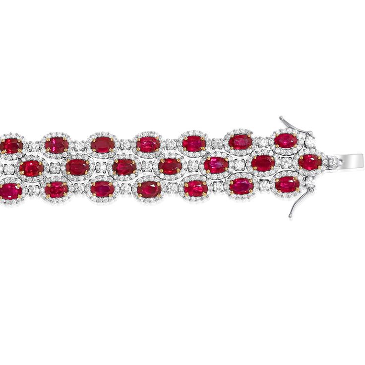 18kt White and Yellow Gold Ruby Diamond Halo Bracelet: 28.00cts of oval shaped rubies held with yellow gold prongs 1.10cts of round diamonds hexagonally packed Three Rows Length: 7.5" Red Diamond Oval Bracelet, Red Oval Diamond Bracelet, Red Diamond Oval Tennis Bracelet, Red Oval Diamond Gemstone Bracelet, Oval Ruby Diamond Bracelet, Luxury Red Oval Bracelet, Roberto Coin Bracelet, Halo Bracelet, Stack Bracelet