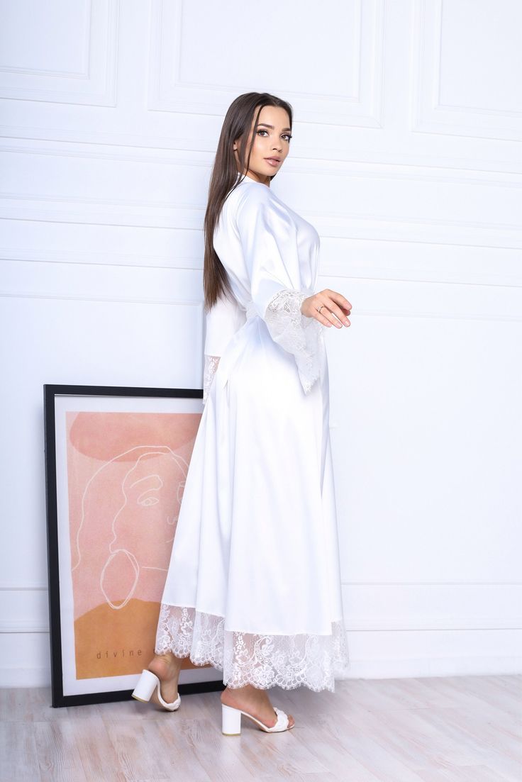 This white long robe is made of high-qualiry silk satin. It has long wide sleeves made of lace and wide belt. When you have one of the most important days in your life, everything should be perfect! You probably planned every minute of this day and now you are ready to make it real. The perfect day starts from the very morning which will be remembered every time you will look at your photos. The bride robe should be beautiful and comfortable at the same time so you could enjoy this day in full! Long Silk Robe, Black Silk Robe, White Bridal Robe, Long Bridal Robe, Long Silk Kimono, Silk Robe Long, Robe Silk, Bridal Kimono, Silk Dressing Gown