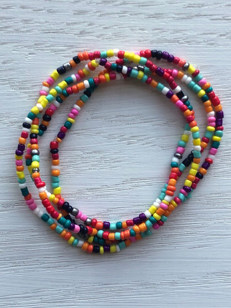 This listing is for a set of four (will add more if desired) seed bead boho beaded bracelets with two shape varieties of earrings. This multi color confetti set has dainty, tiny beads and are strung on strong elastic. They are double knotted and glued shut. This bracelet and earring set goes with a variety of outfits, and is easy on/off. It's one of those quick additions that makes a difference in your look.   Bracelets are 7 inches around Earrings have around a 1.5 or 2 inch drop length Bohemian Beaded Stretch Bracelet For Everyday, Adjustable Multicolor Tiny Beads Jewelry, Adjustable Multi-strand Colorful Bead Jewelry, Adjustable Multi-strand Colorful Beaded Jewelry, Colorful Beaded Bohemian Stretch Bracelet, Colorful Bohemian Beaded Stretch Bracelet, Festival Heishi Beads Stretch Bracelet, Faceted Bead Bracelets For Festivals, Colorful Bohemian Bracelets With Tiny Beads