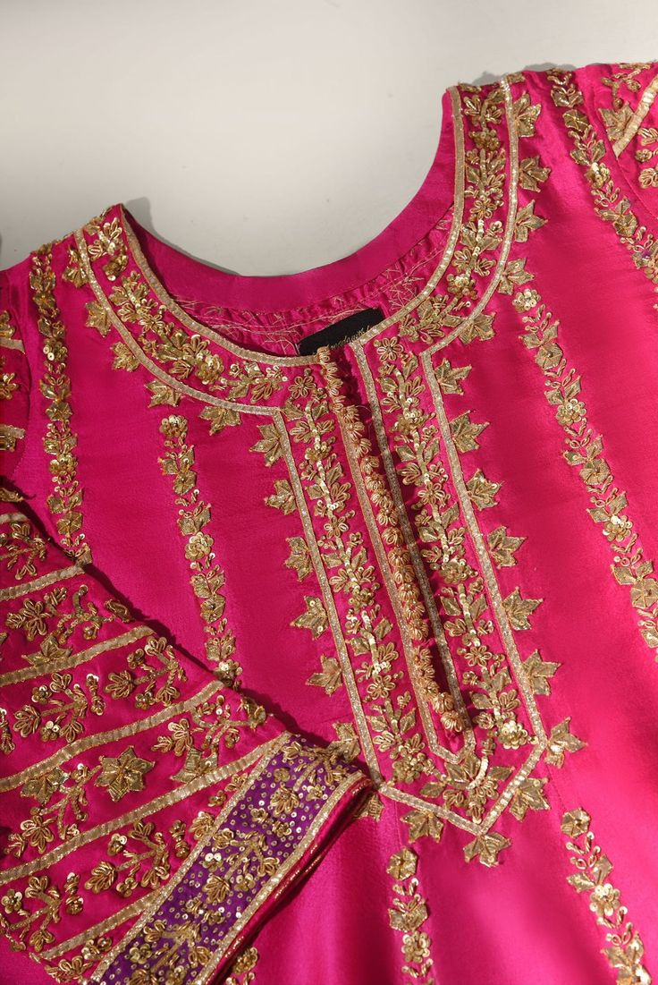 This beautiful three piece is designed on pure fuschia raw silk heavily embellished with pretty hand gotah zardosi ( handwork/ada ) details. Paired with a regal tye dye pure  dupatta with fuchsia pure chundri dupatta with goti phool spray. The length of the panelled pishwas is 48 inches. An alluring three piece for you