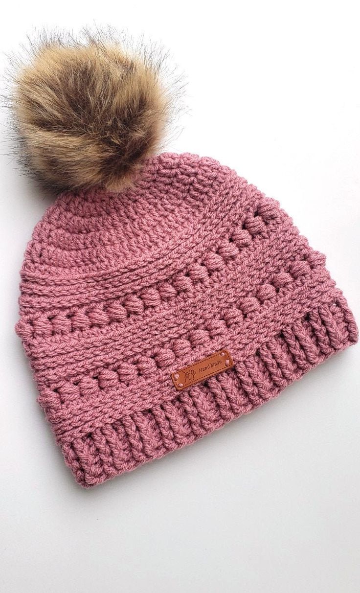 This women's winter hat is hand crocheted using a very soft 100% acrylic yarn in a beautiful rose pink color. The detailed texture of the hat will go well with any kind of outfit, casual or dressed up.  It is long enough and will keep your ears warm while making you look super cute! It also makes a great birthday or Christmas gift for either a teenager or an adult. **Measurements: It has a circumference of 19" and 9 1/4 in height excluding the pom pom.  It should easily fit an average teen or ad Pink Crochet Hat Warm And Cozy, Cozy Pink Crochet Beanie Hat, Cozy Pink Yarn Beanie, Cozy Warm Pink Crochet Hat, Pink Yarn Crochet Hat For Gift, Pink Crochet Hat Made Of Yarn As A Gift, Pink Crochet Hat As A Gift, Pink Crochet Yarn Hat As Gift, Cozy Pink Yarn Hat