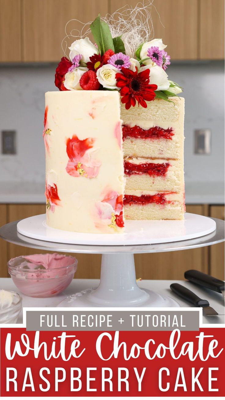 a white chocolate raspberry cake with flowers on top and the words full recipe + video